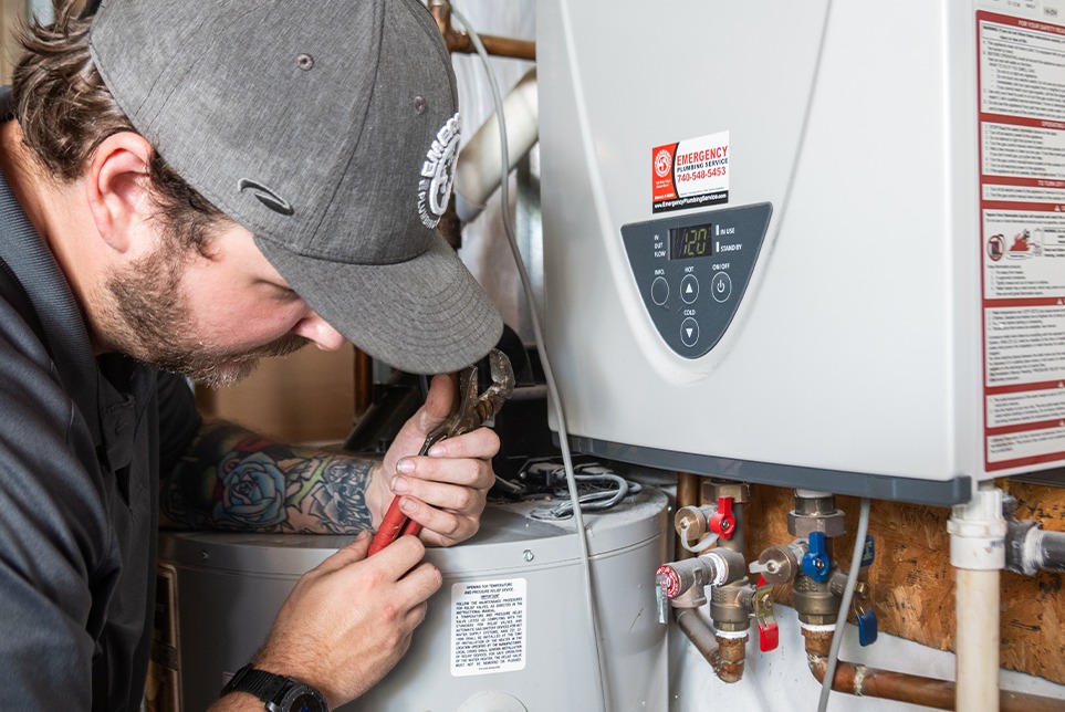 Plumber installs a water heater. 