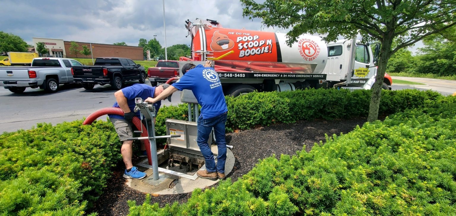 A service truck from "Poop Scoop N' Boogie Septic Tank Pumping" services a sewage system. 