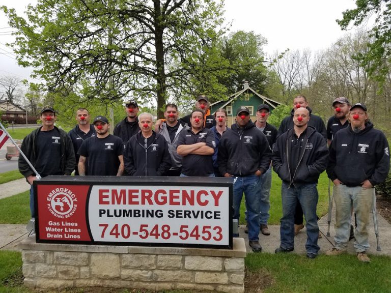 A team from Emergency Plumbing Services is posing for a group photo while wearing Red Noses